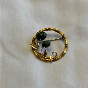 Gold-Tone Circle Brooch with Green Stone Accents